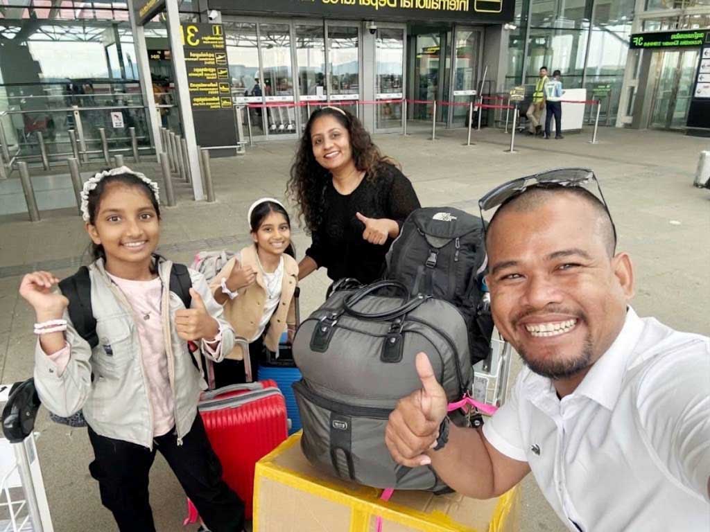 Happy family travelers arriving with private driver at Siem Reap Angkor International Airport (SAI) departure terminal