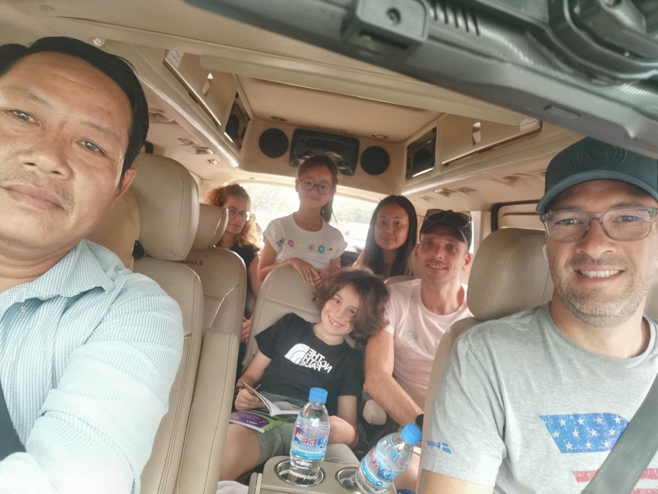 TAXICAMBODIA driver with happy passengers inside private taxi transfer